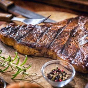 Spur steak on chopping board