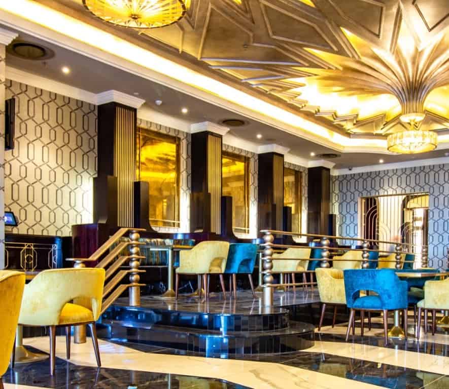 Suncoast Casino restaurant interior seating with yellow and blue velvet seats