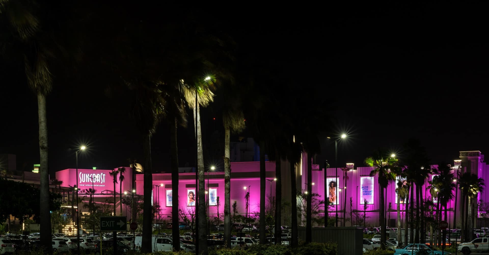 Suncoast Casino with pink exterior lighting at night